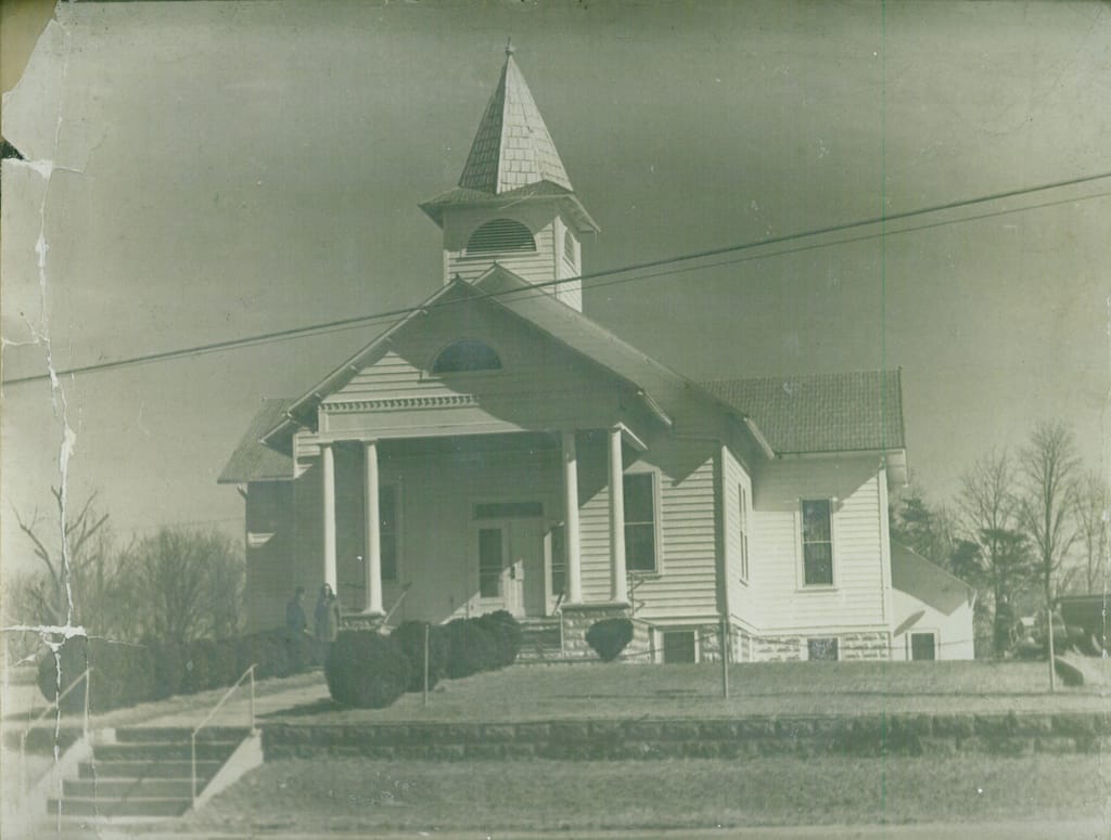 A photo of the front entrance of the SPUMC sanctuary building from HG Trueman Road looking northwards, in grayscale, taken prior to the construction of any other campus buildings.