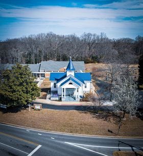 An aerial photo of the SPUMC sanctuary facade, backed by the CLC, taken from directly above the Cove Point Rd / HG Trueman Rd intersection and looking northeastwards.
